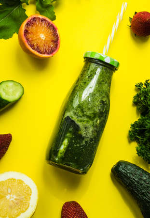 Organic and healthy green smoothie with banana, spinach, avocado, citrus fruits and chia seeds in a...