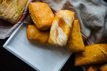 Freshbaked homemade french bread on rustic backgroundの写真素材