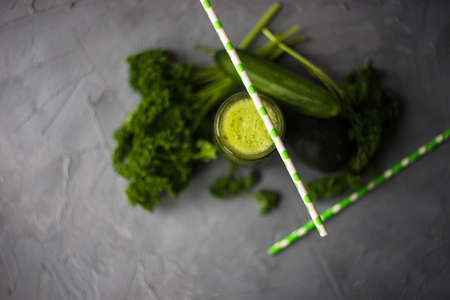 Organic and healthy green smoothie with banana, spinach, avocado, citrus fruits and chia seeds in a glass bottles on a rustic background withcopy spaceの写真素材