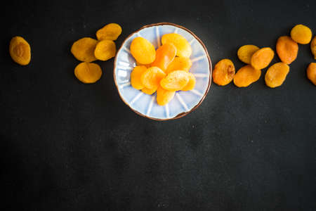 Organic dried apricot in a rustic bowl with copy spaceの写真素材