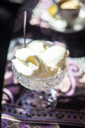 Vanila ice cream in vintage crystal cup on old tableの写真素材