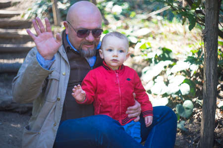 Dad and baby boy playing outdoor in a spring time park