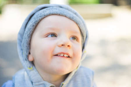 Smiling baby boy playing in a park portrait