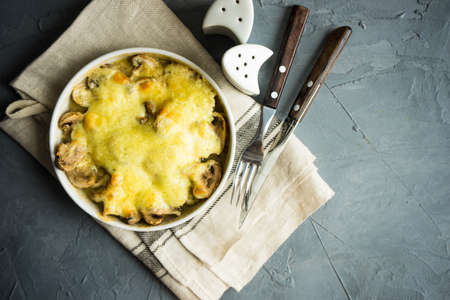 Traditional georgian mushrooms with suluguni cheese on rustic background