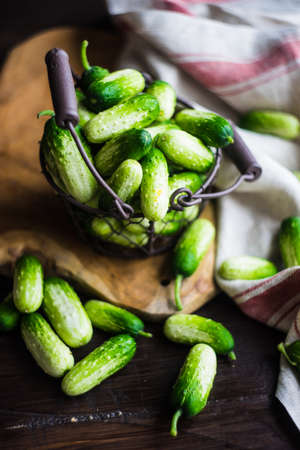 Organic cucumbers on rustic wooden background with copy space as a healthy food conceptの写真素材