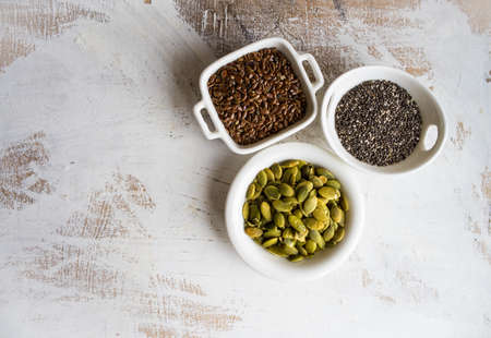 Bowl of various superfoods on white wooden background with copy spaceの写真素材
