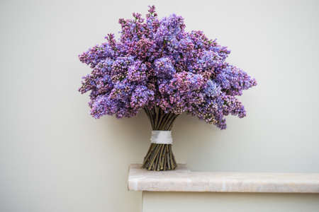 Beautiful purple lilac flowers in a bunch on rustic background with copy spaceの写真素材