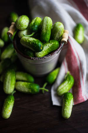 Organic cucumbers on rustic wooden background with copy space as a healthy food conceptの写真素材
