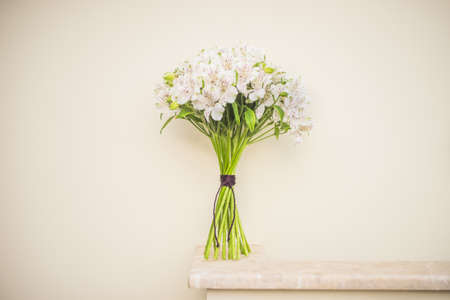 White Lily of the Incas in a bunch on rustic background with copyspaceの写真素材