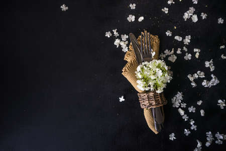 Summer table setting with white  Viburnum opulus 'Roseum' flowers on rustic background