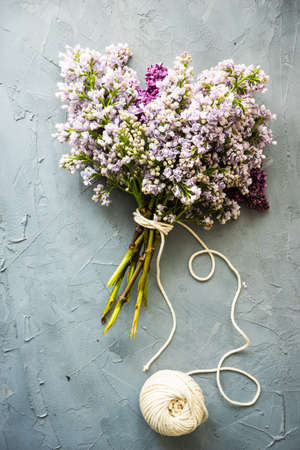 Two colors lilac flowers in bunch on concrete background with copy spaceの写真素材