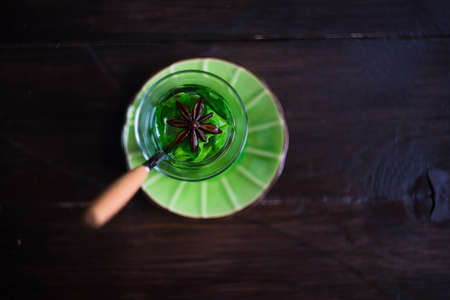 Traditional mint tea in glass cup on dark wooden table with copy spaceの写真素材