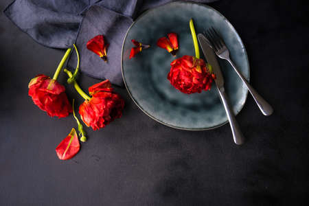 Summer table setting decorated with Red Princess tulips on rustic backgroundの写真素材