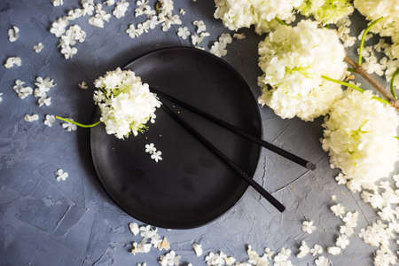 Summer table setting with white  Viburnum opulus 'Roseum' flowers on rustic backgroundの写真素材
