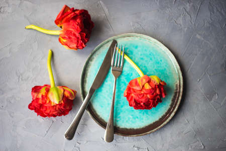 Summer table setting decorated with Red Princess tulips on rustic backgroundの写真素材