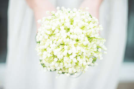 Beautiful may lilies in bride bunch on rustic background with copy spaceの写真素材