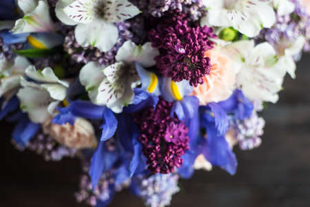 Beautiful Alstroemeria, lilac and iris flowers in bride bunch on rustic background with copy spaceの写真素材