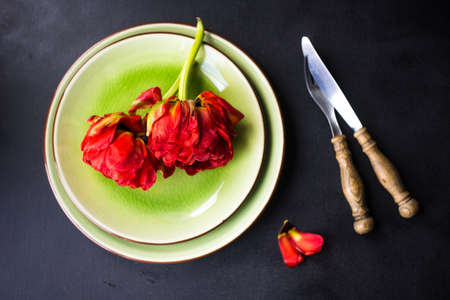Summer table setting decorated with Red Princess tulips on rustic backgroundの写真素材