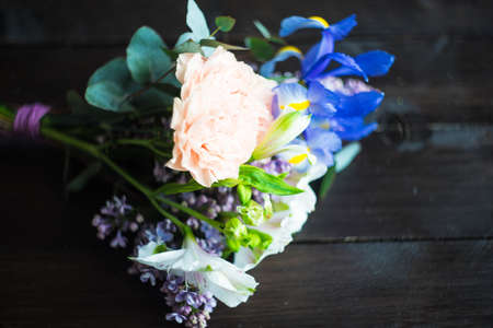 Beautiful Alstroemeria, lilac and iris flowers in bride bunch on rustic background with copy spaceの写真素材