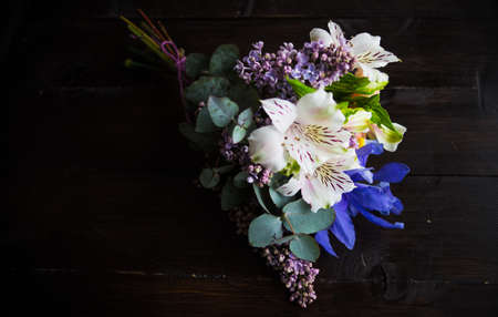 Beautiful Alstroemeria, lilac and iris flowers in bride bunch on rustic background with copy spaceの写真素材