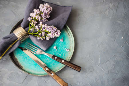 Spring table setting  with lilac flowers on rustic table with copy space