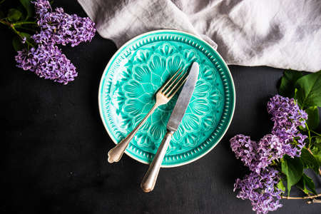 Spring table setting  with lilac flowers on rustic table with copy space