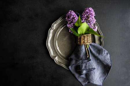 Spring table setting  with lilac flowers on rustic table with copy spaceの写真素材