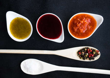 Three the most famous georgian sauces - satsebeli, green and red tkemali on dark background with copy spaceの写真素材