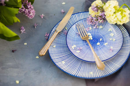 Spring table setting  with lilac flowers on rustic table with copy spaceの写真素材
