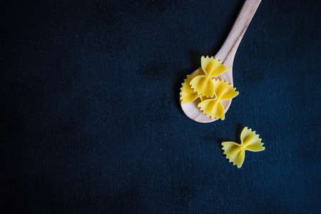 farfalle pasta in a bowl on rustic background with copy space