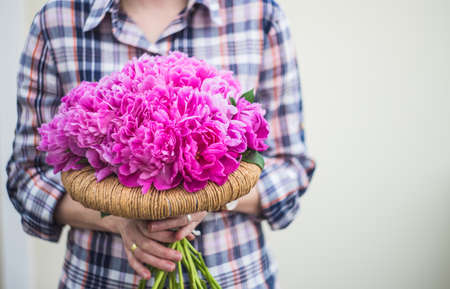 Summer floral concept with bright pink peony flowers on rustic background with copy spaceの写真素材