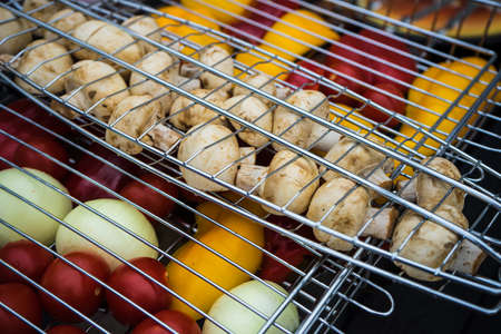 Fresh vegetables and mushrooms on a grill as a healthy food conceptの写真素材