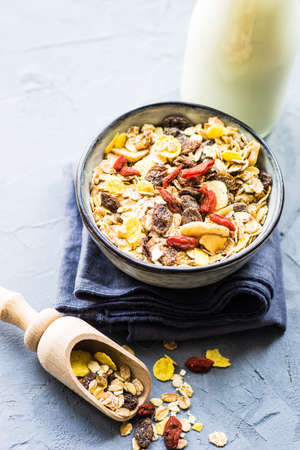 Healthy brekfast concept with  oatmeal, superfood, honey and milk on rustic background with copy...