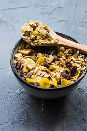 Healthy brekfast concept with  oatmeal, superfood, honey and milk on rustic background with copy...