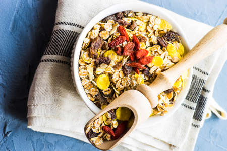 Healthy brekfast concept with  oatmeal, superfood, honey and milk on rustic background with copy spaceの写真素材