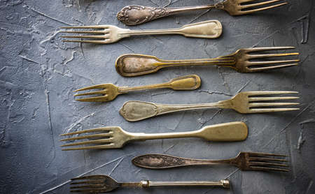 Flatlay with vintage forks on concrete background with copy spaceの写真素材