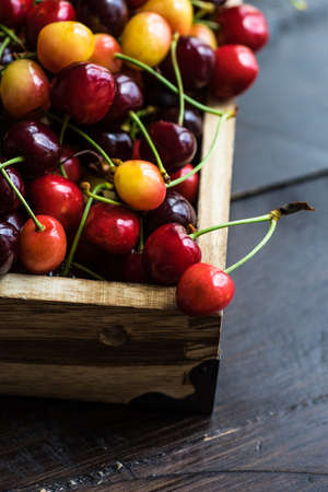 Fresh organic sweet cherries in wooden box with copy spaceの写真素材