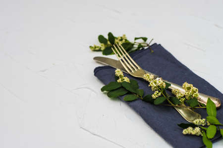 Summer floral rustic table setting on white concrete background with copy space