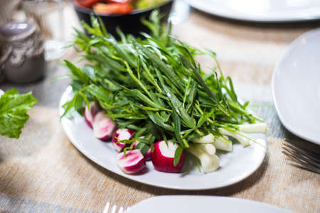 Traditional georgian table serving supra with greens and salads