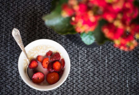 Healthy breakfast concept with oatmeal and strawberries on rustic background with copy spaceの写真素材