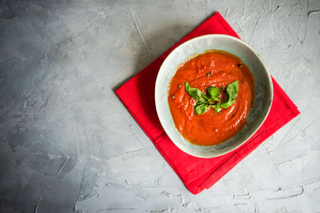 Traditional spanish tomato cream soup Gazpacho in ceramic bowl on concrete background with copy space