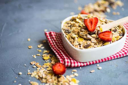 Healthy breakfast concept with oatmeals and strawberries on concrete tableの写真素材
