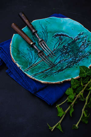 Rustic table setting with ceramic plate and vintage silverwareの写真素材