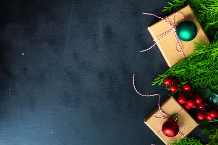 Christmas frame with gift boxes and christmas decor on blackboard with copy space