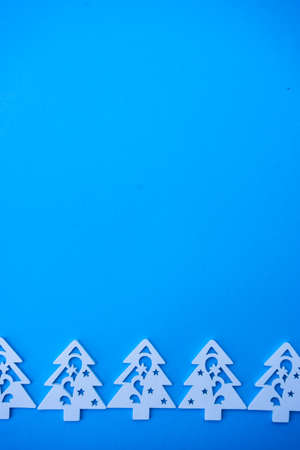 Christmas frame with white holiday decor on blue background with copy spaceの写真素材