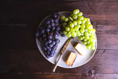 Cheese concept with famous georgian suluguni cheese in saperavi wine with fruits and spices on...