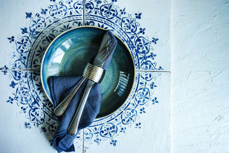 Table served for dinner on moorish vintage tiles with copy spaceの写真素材