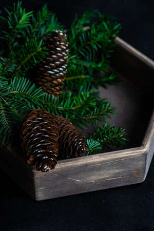 Christmas holiday concept with wooden box full of festive decor on dark backgroundの写真素材