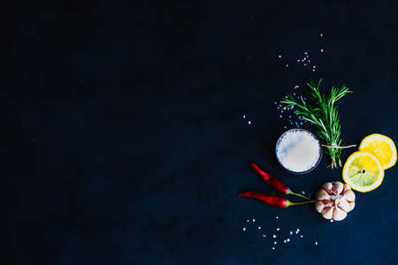 Herbs and spices on dark wooden background as a cooking ingredients concept with copy spaceの写真素材