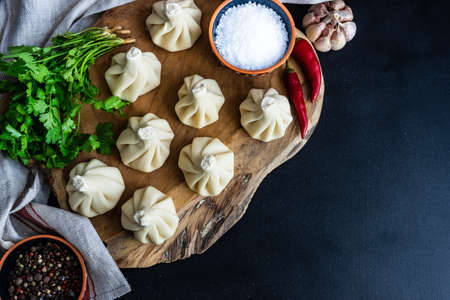 Famous georgian dish meat khinkali uncooked on cutting board with copy spaceの写真素材